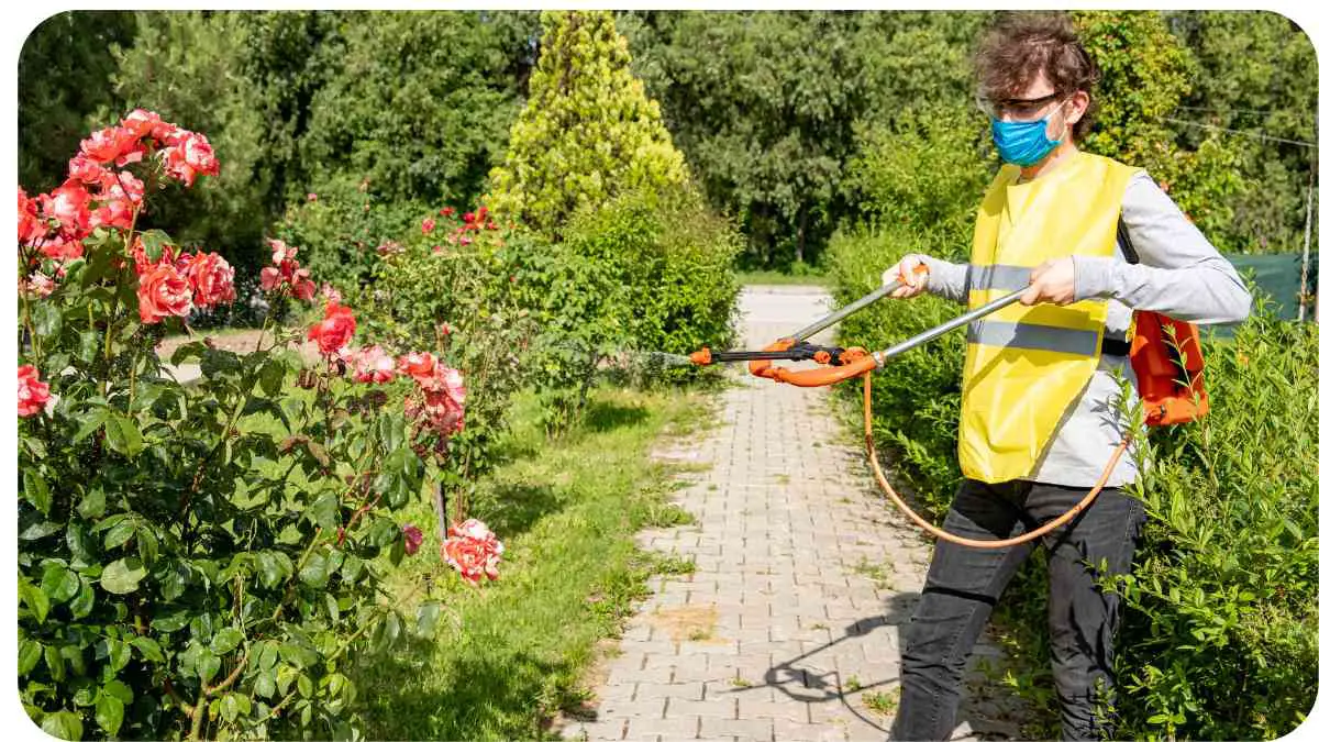 a person in a yellow vest and face mask using a weed trimmer