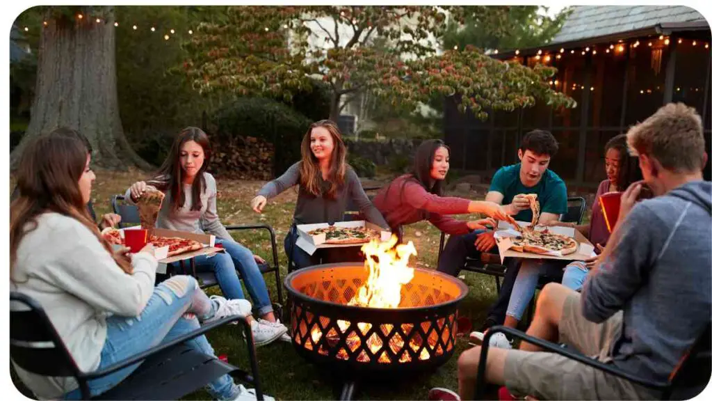 a group of people sitting around an outdoor fire pit