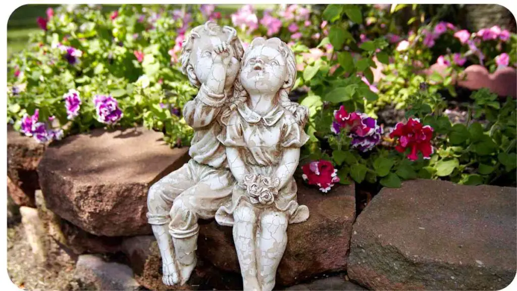 a statue of a boy and girl sitting on a rock