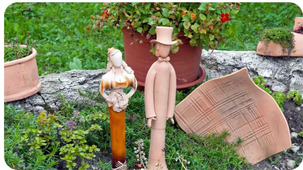 two clay figurines in a garden