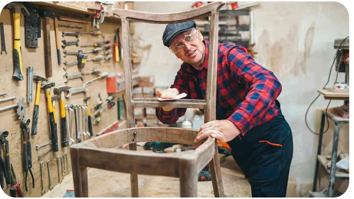 a person is working on a chair in a workshop